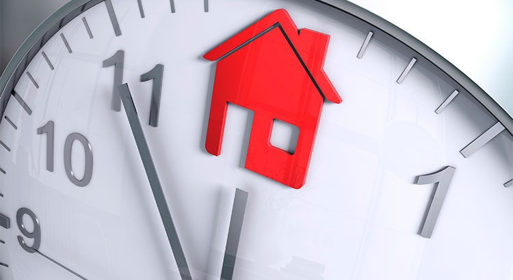 Clock with hour hand on an image of a house