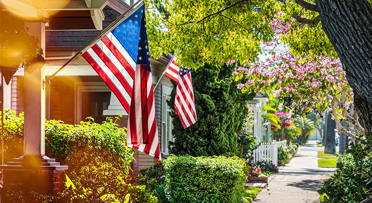 American flags hanging in front of houses