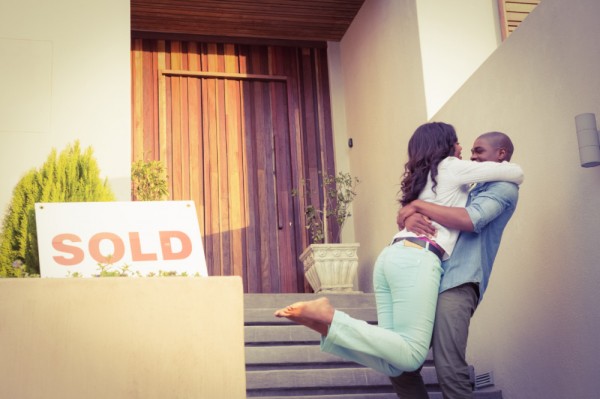 man hugging a woman and lifting her up because they sold their home